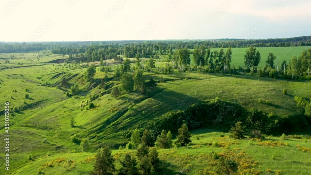 Aerial video, flying a quadcopter over a beautiful landscape of fields, forests and ravines Aerial video, flying a quadcopter over a beautiful landscape of fields, forests and ravines