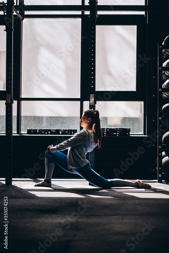 Portrait of attractive young woman doing yoga or pilates exercise
