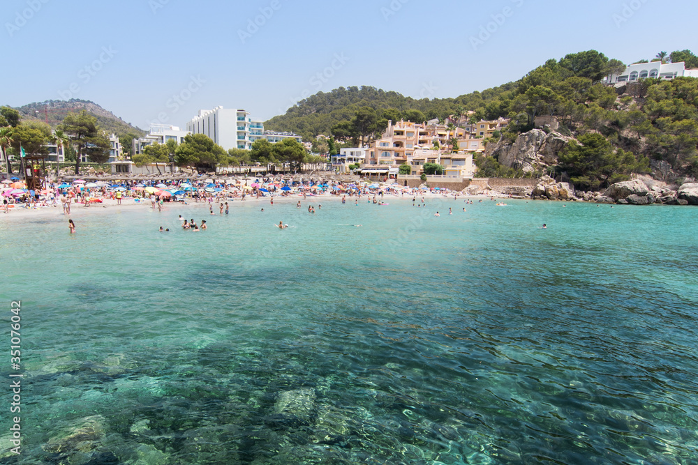 Beach with people and sea landscape in Camp de Mar, Majorca