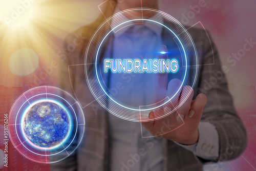 Conceptual hand writing showing Fundraising. Concept meaning act of collecting or producing money for a particular purpose Elements of this image furnished by NASA photo