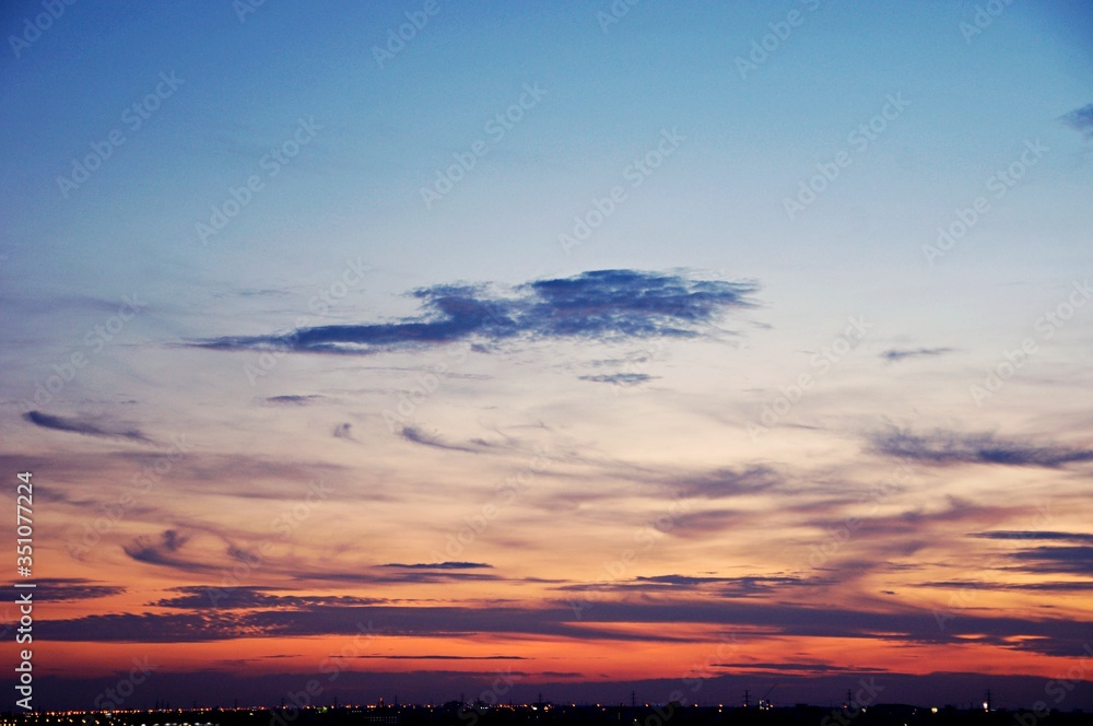Fototapeta premium The atmosphere , Beautiful sky painted by the sun leaving bright golden shades . Dense clouds in twilight sky in winter evening . Evening sky scene with golden light from the setting sun