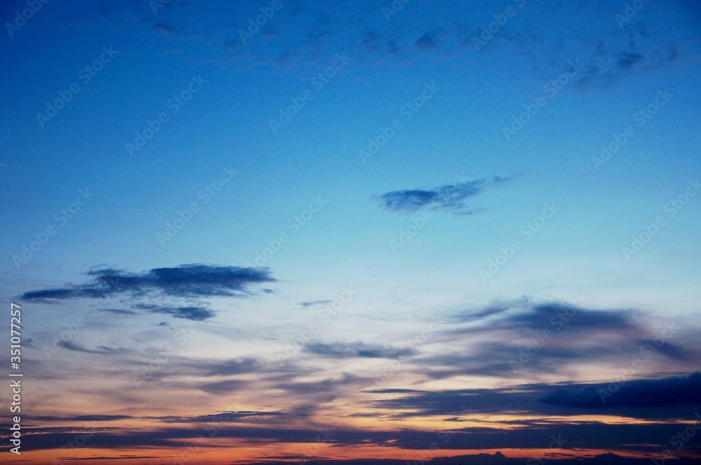 The atmosphere , Beautiful sky painted by the sun leaving bright golden shades . Dense clouds in twilight sky in winter evening . Evening sky scene with golden light from the setting sun