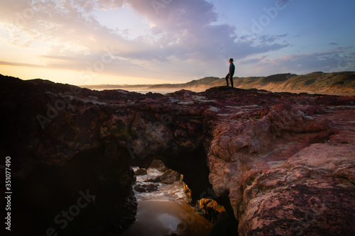 man standing on rock 