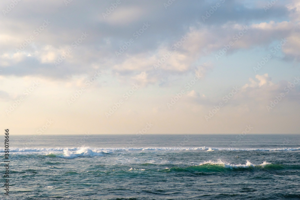 Fototapeta premium Delicate colors of dawn over the ocean. A minimalistic view of the tropical sea with beautiful pastel colors. For design and networking