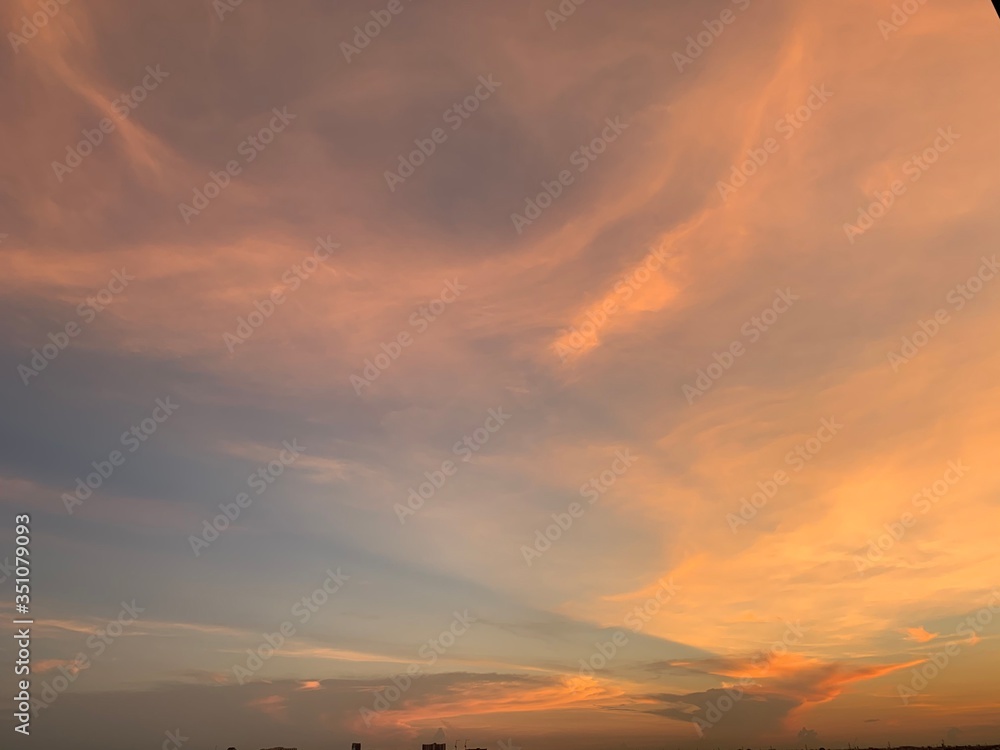 Background of colorful sky concept: Dramatic sunset with twilight color sky and clouds, Natural colors Evening sky Shine new day for Heaven,The light from heaven from the sky is a mystery.