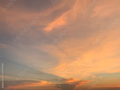 Background of colorful sky concept: Dramatic sunset with twilight color sky and clouds, Natural colors Evening sky Shine new day for Heaven,The light from heaven from the sky is a mystery. © tpap8228