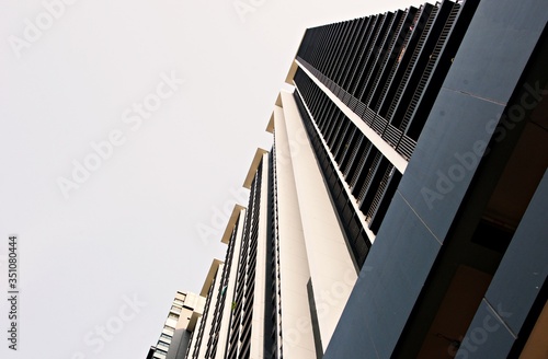 Part of Modern residential apartment. Detail of New luxury home complex. Fragment of City Real estate property and condo architecture. Copy space. Blue sky