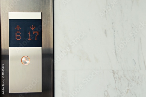 Elevator Button up and down direction with digital number on the marble wall