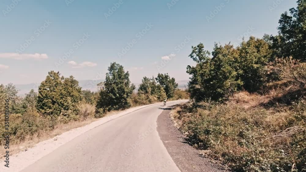 Action shot of a man mountain biking through the Macedonian countryside during the summer. Helmet mount, tracking shot. Action shot of a man mountain biking through the Macedonian countryside during the summer. Helmet mount, tracking shot.