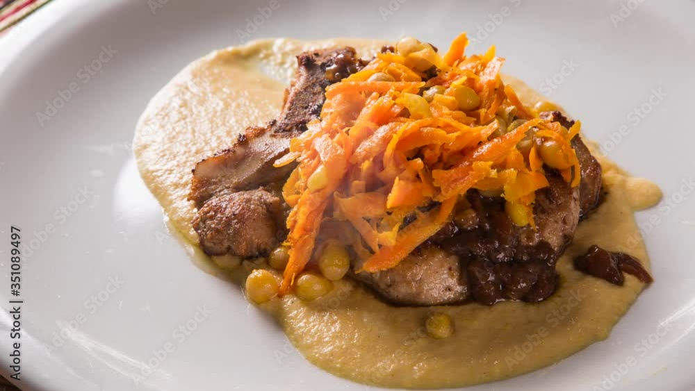 pork chop with barbecue sauce and corn musseline with carrot. Front view with smoke. pork chop with barbecue sauce and corn musseline with carrot. Front view with smoke.