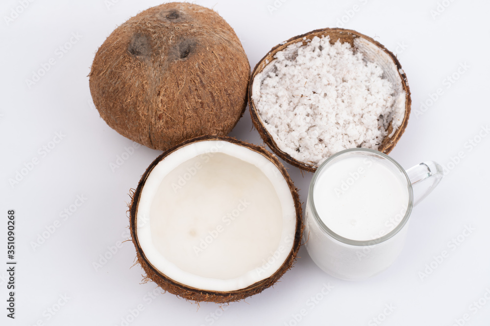 Coconut and a glass of coconut milk isolatd on white background. Healthy food. Coconut and a glass of coconut milk isolatd on white background. Healthy food.