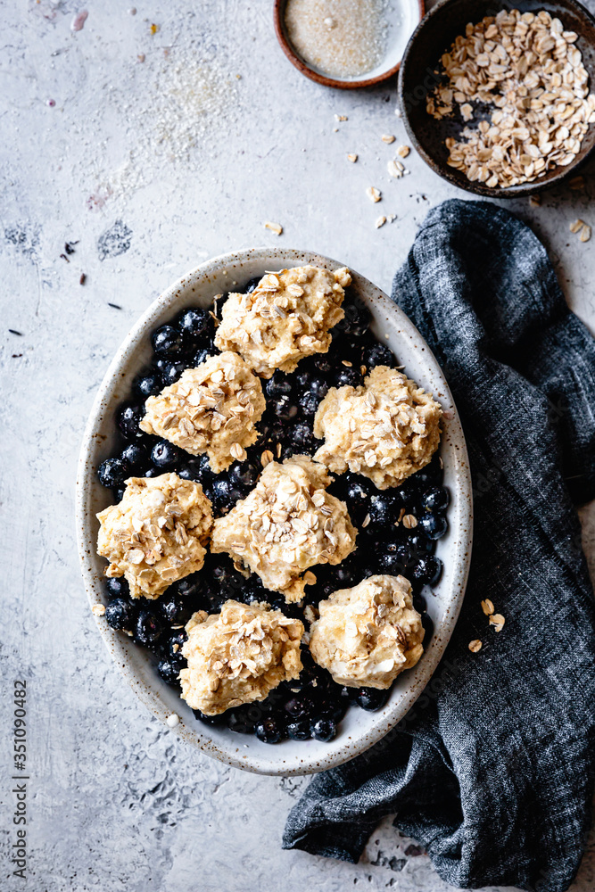 Prepared blueberry cobler with oat bisuits ready for baking. Prepared blueberry cobler with oat bisuits ready for baking.