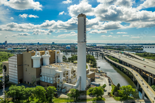 Aerial view of the Wheelabrator Baltimore, a waste management service with a tall chimney next to the I-95 and I-395 highway junction in Maryland USA