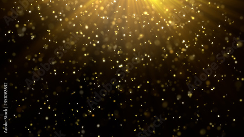 Golden confetti over black background with golden rays shining from the top