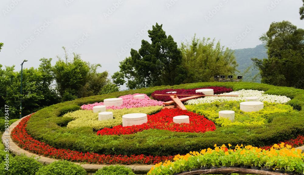 Floral clock at the Yangmingshan national park. A big clock composition by various blossom flowers.