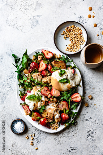 Strawberry burrata panzanella salad with balsamic vinaigrette. photo