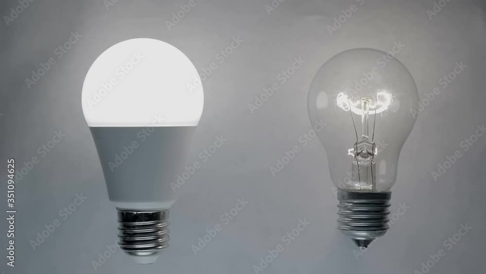 Energy-saving, eco-friendly Led bulb lamp compared to a classic glass tungsten filament lamp are lights up on a light background. Closeup Energy-saving, eco-friendly Led bulb lamp compared to a classic glass tungsten filament lamp are lights up on a light background. Closeup