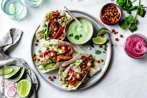 Sweet potato chickpea tacos with cilantro cream served on plate photo