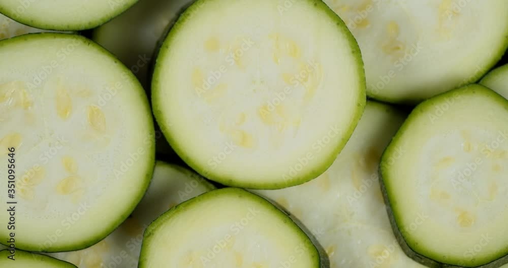 Round slices of zucchini slowly rotate. Round slices of zucchini slowly rotate.