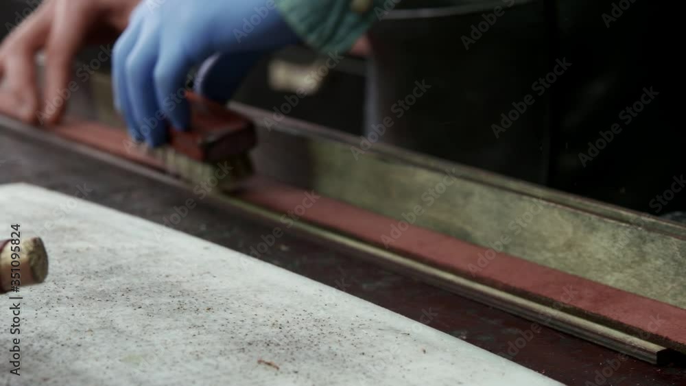 Close up of process of manufacturing a leather belt by a tanner. Workshop tanner. Close up of process of manufacturing a leather belt by a tanner. Workshop tanner.