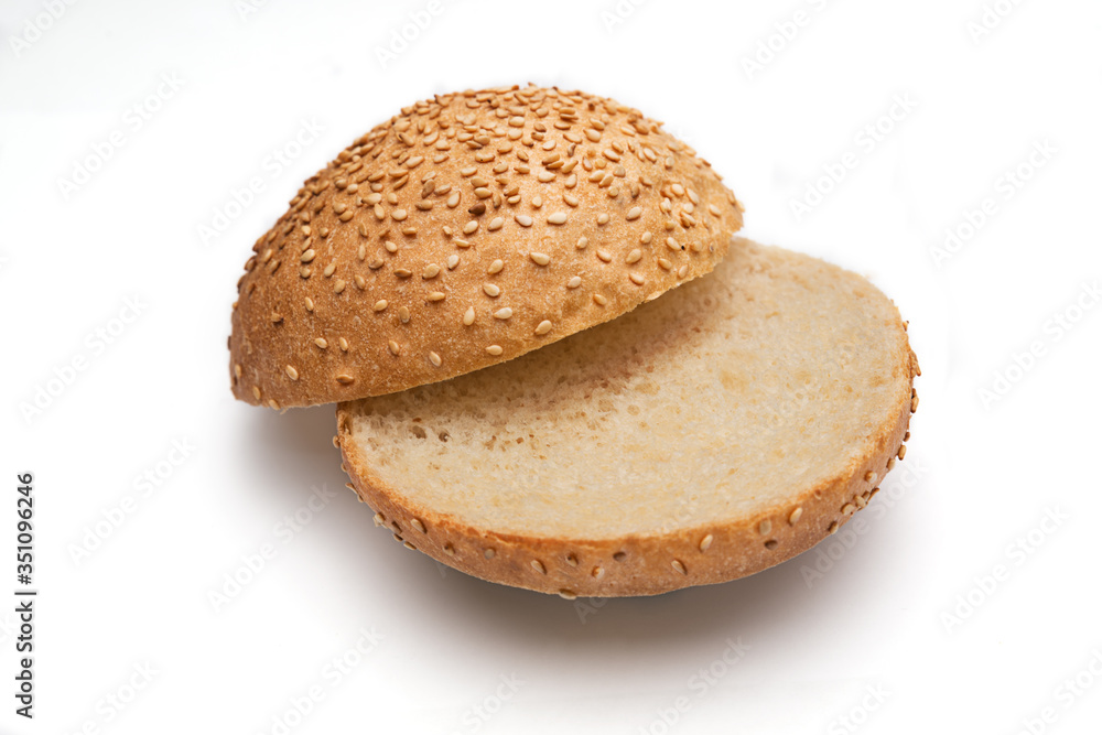 Fresh fragrant bun for burgers with sesame seeds on a white background. Can be used for advertising Fresh fragrant bun for burgers with sesame seeds on a white background. Can be used for advertising