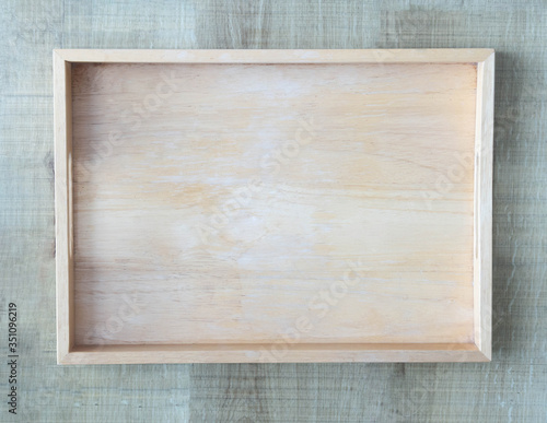 Empty wooden tray on wood table background, Top view © mraoraor