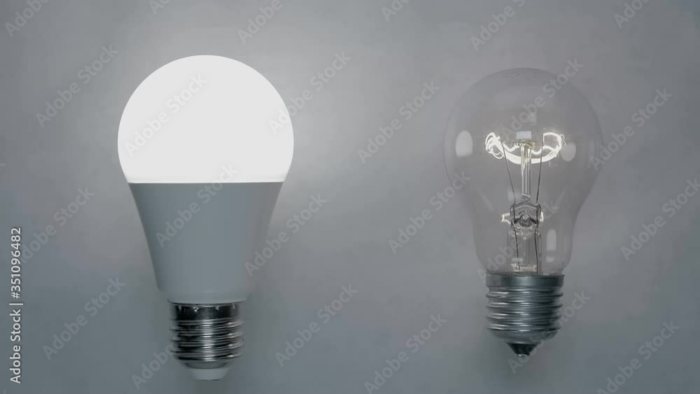 Energy-saving, eco-friendly Led bulb lamp compared to a classic glass tungsten filament lamp are lights up on a light background. Flickering light bulb. Closeup Energy-saving, eco-friendly Led bulb lamp compared to a classic glass tungsten filament lamp are lights up on a light background. Flickering light bulb. Closeup