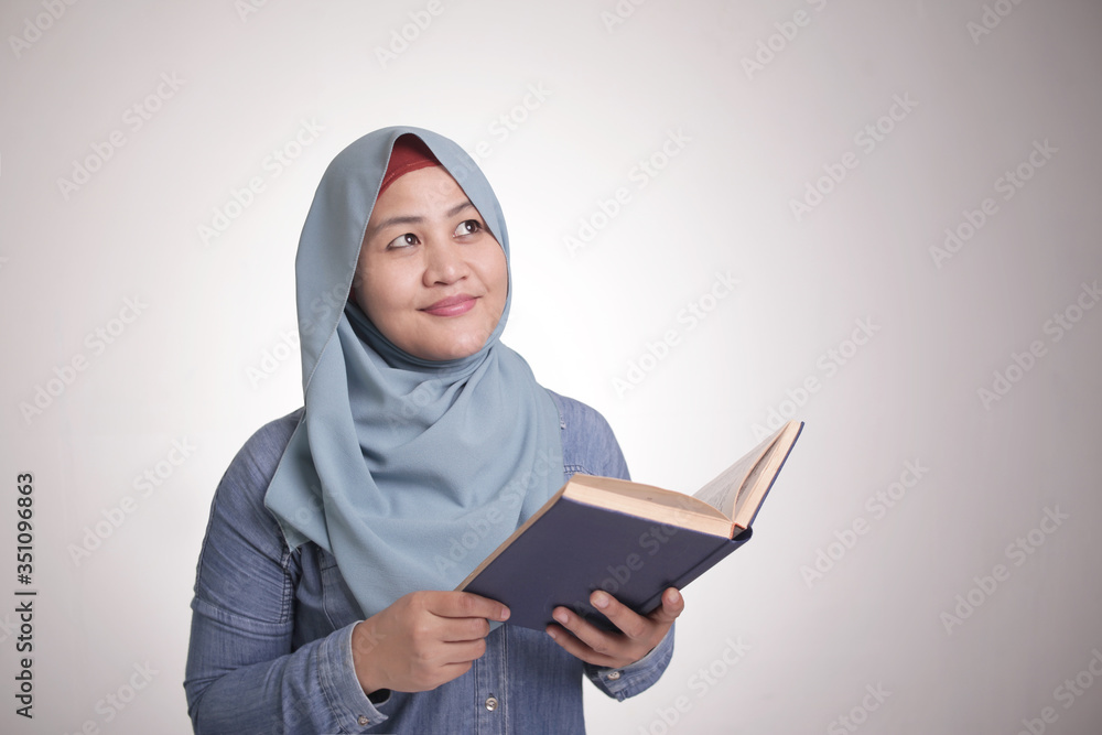Muslim Woman Reading Book and Thinking Muslim Woman Reading Book and Thinking