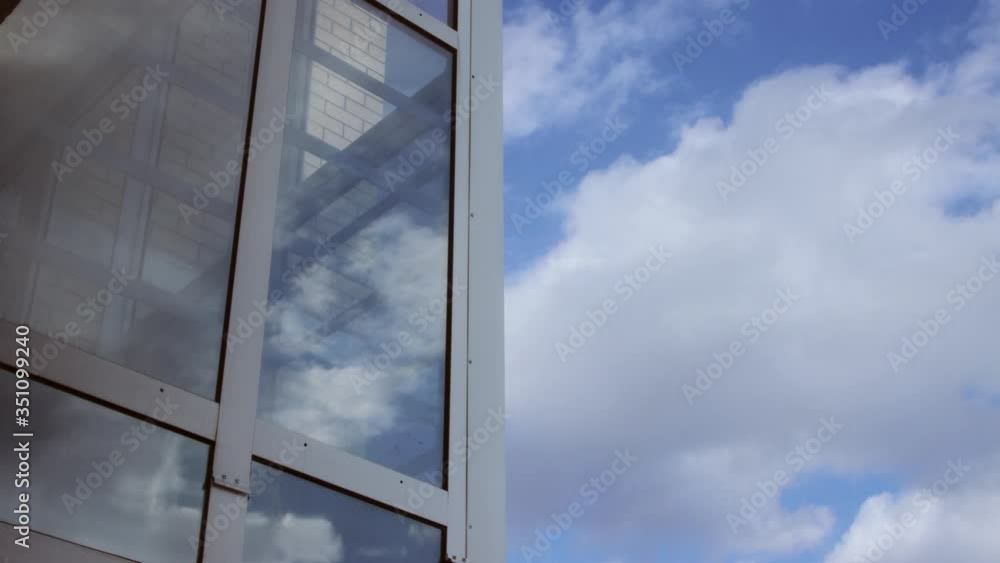 Timelapse of clouds on blue sky and as reflection on glass Timelapse of clouds on blue sky and as reflection on glass