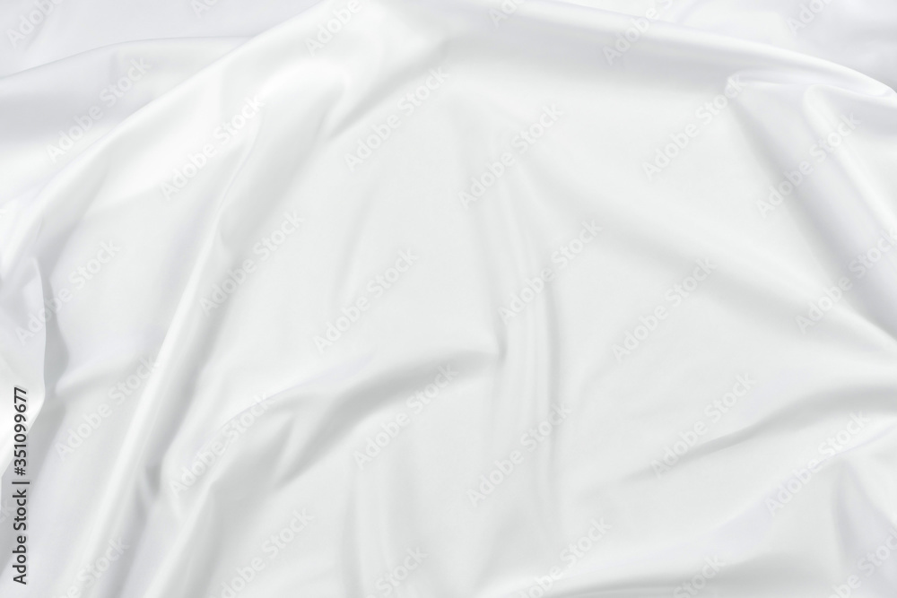 Abstract white fabric texture background. Cloth soft wave. Creases of satin, silk, and cotton.	