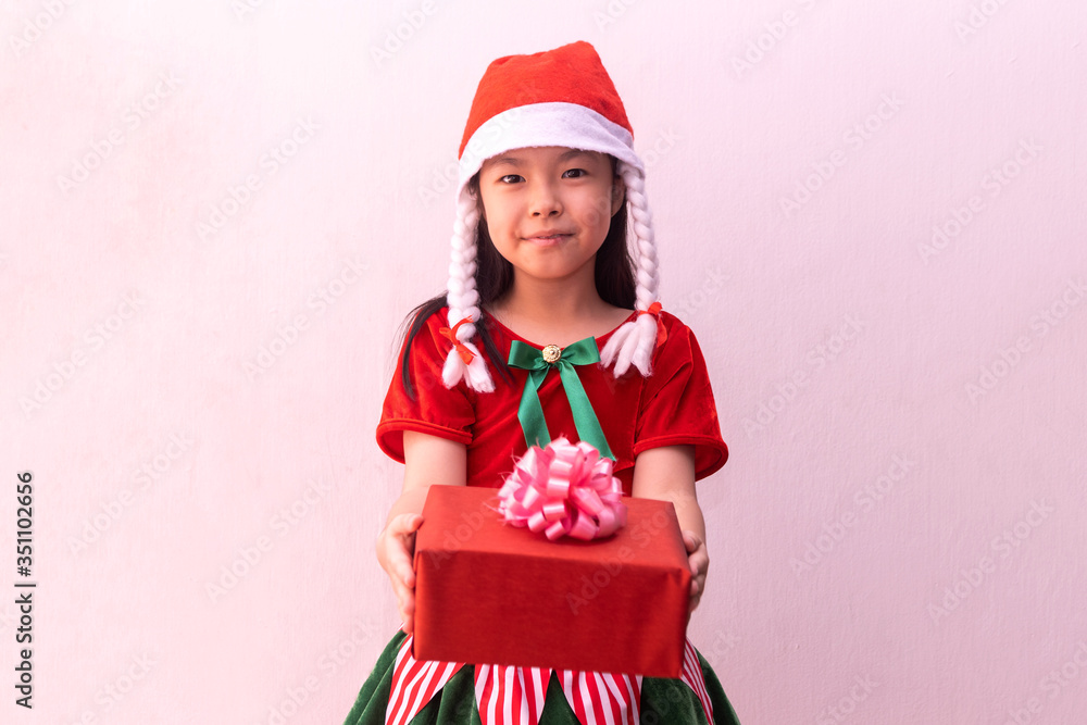 Asian girl in Elf clothes holding gift. Merry christmas Asian girl in Elf clothes holding gift. Merry christmas