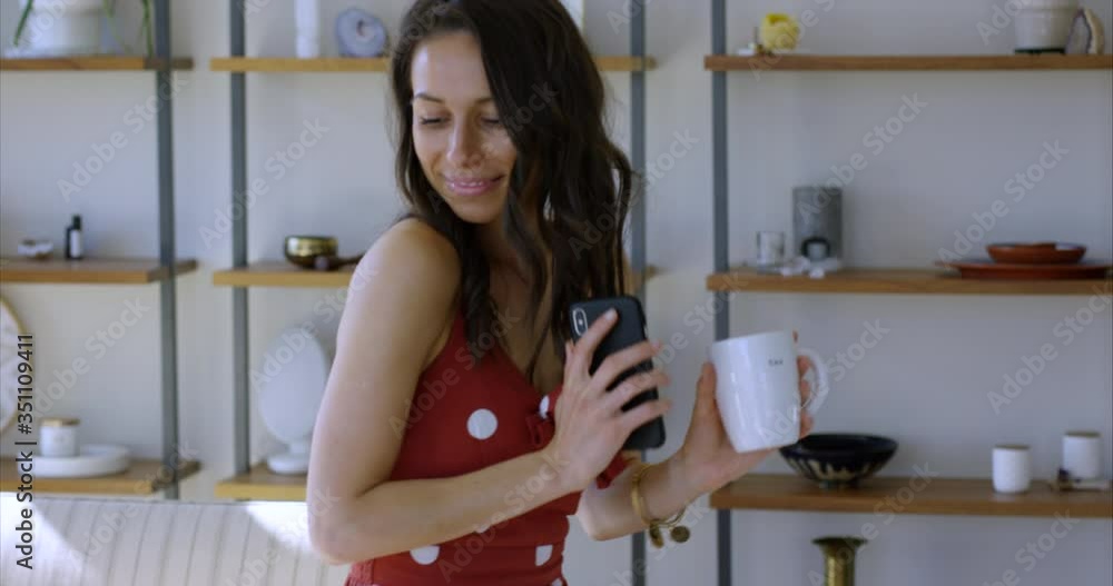 Woman drinking morning coffee dancing in living room - medium shot Woman drinking morning coffee dancing in living room - medium shot