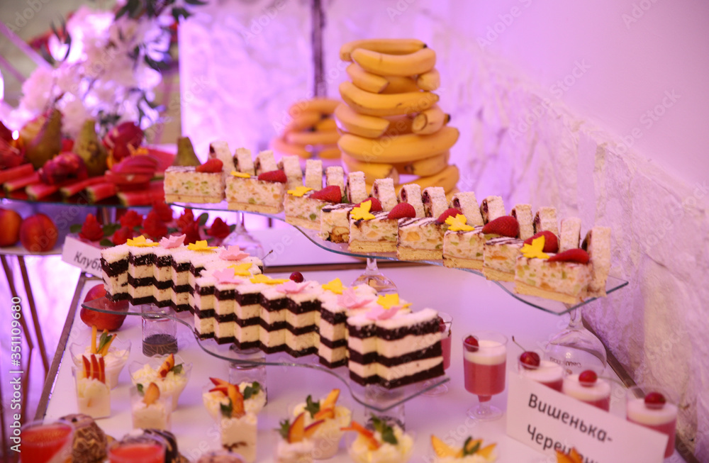 Delicious sweets on wedding candy buffet with desserts, cupcakes
