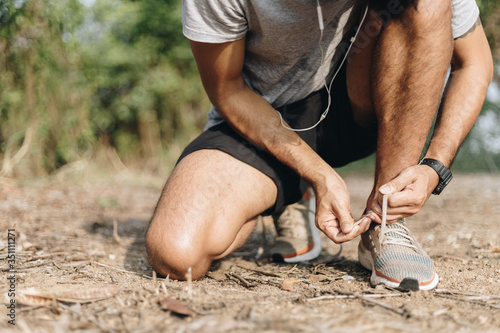 Sport man tied shoes with exercise and running, Exercise for health concept