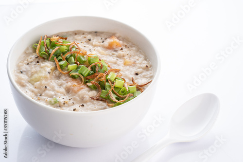 ramadhan famous food bubur lambuk in a white bowl and background