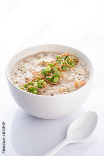 ramadhan famous food bubur lambuk in a white bowl and background
