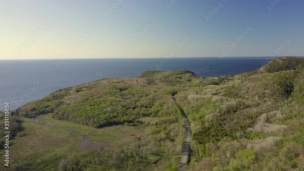 Aerial view of New England coastline with boat in background. Aerial view of New England coastline with boat in background.