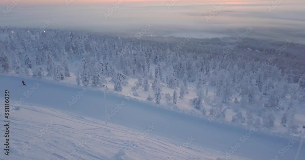 Ariel view of a snowboarder during sunset in Lapland Finland Ariel view of a snowboarder during sunset in Lapland Finland