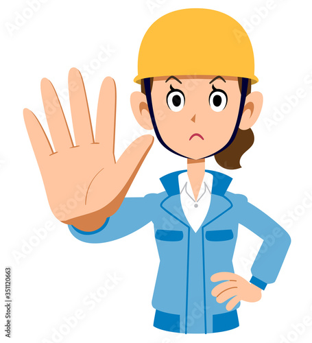 制止するヘルメットを被った青い作業着の女性
