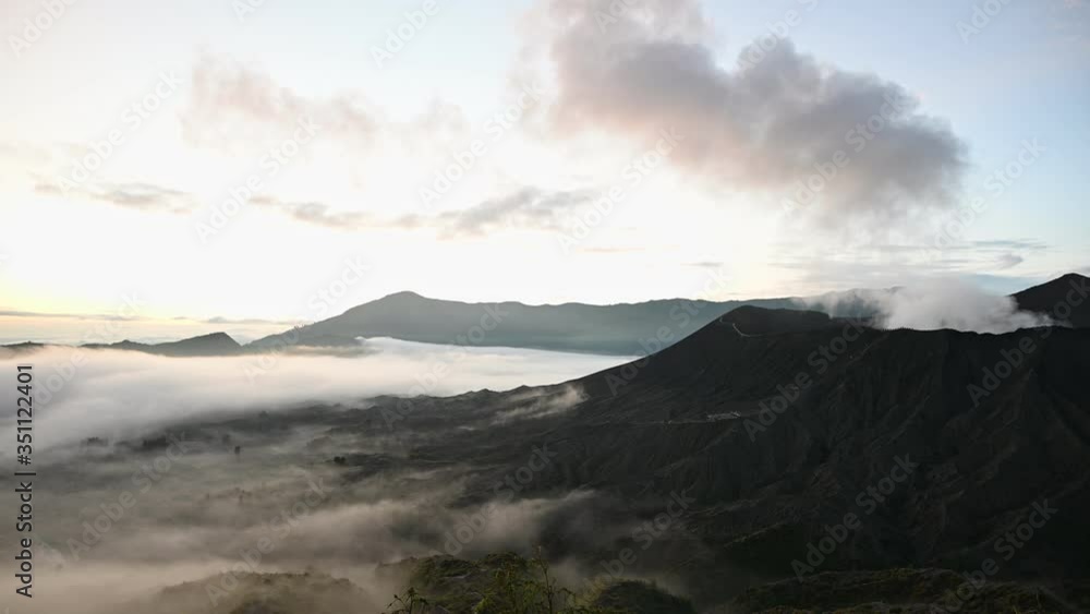 A group of clouds in the sky over a volcano A group of clouds in the sky over a volcano