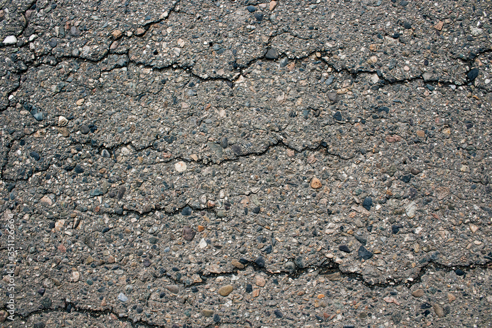 Old worn and cracked asphalt with cracks. Cracked asphalt background. Gray asphalt background Old worn and cracked asphalt with cracks. Cracked asphalt background. Gray asphalt background