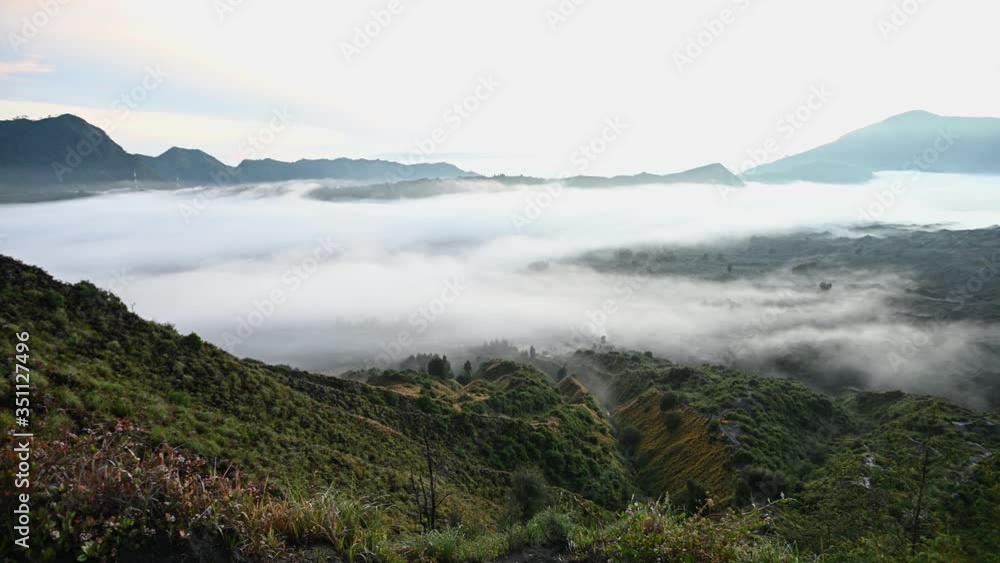 A group of clouds in the sky over a volcano A group of clouds in the sky over a volcano
