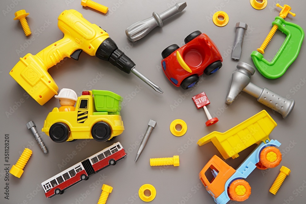 Toys background, set of toy contruction tools, cars, boys playing, flat lay. Toys background, set of toy contruction tools, cars, boys playing, flat lay.