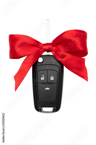 Car keys with red bow over white background. Isolate.