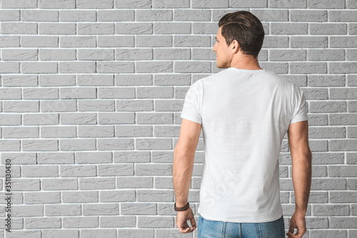 Man in stylish t-shirt on b...