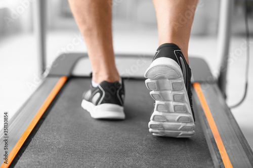 Senior man training on treadmill in gym, closeup