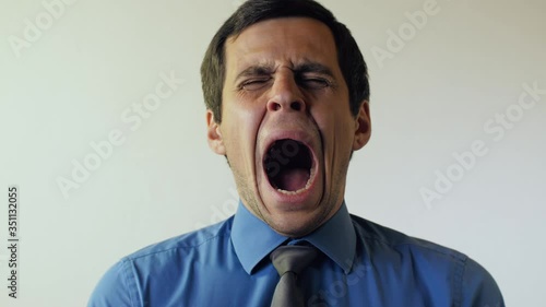 Yawning man in blue shirt