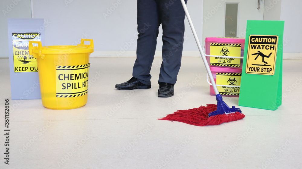 Janitor male cleaning floor in medical service room or laboratory with