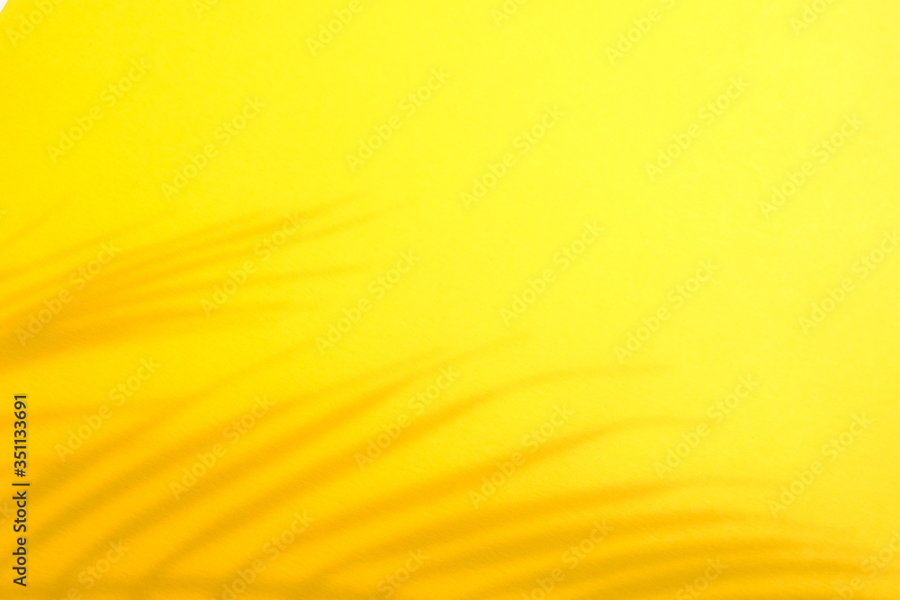 Abstract background of shadows palm leaves on a yellow background. Abstract background of shadows palm leaves on a yellow background.