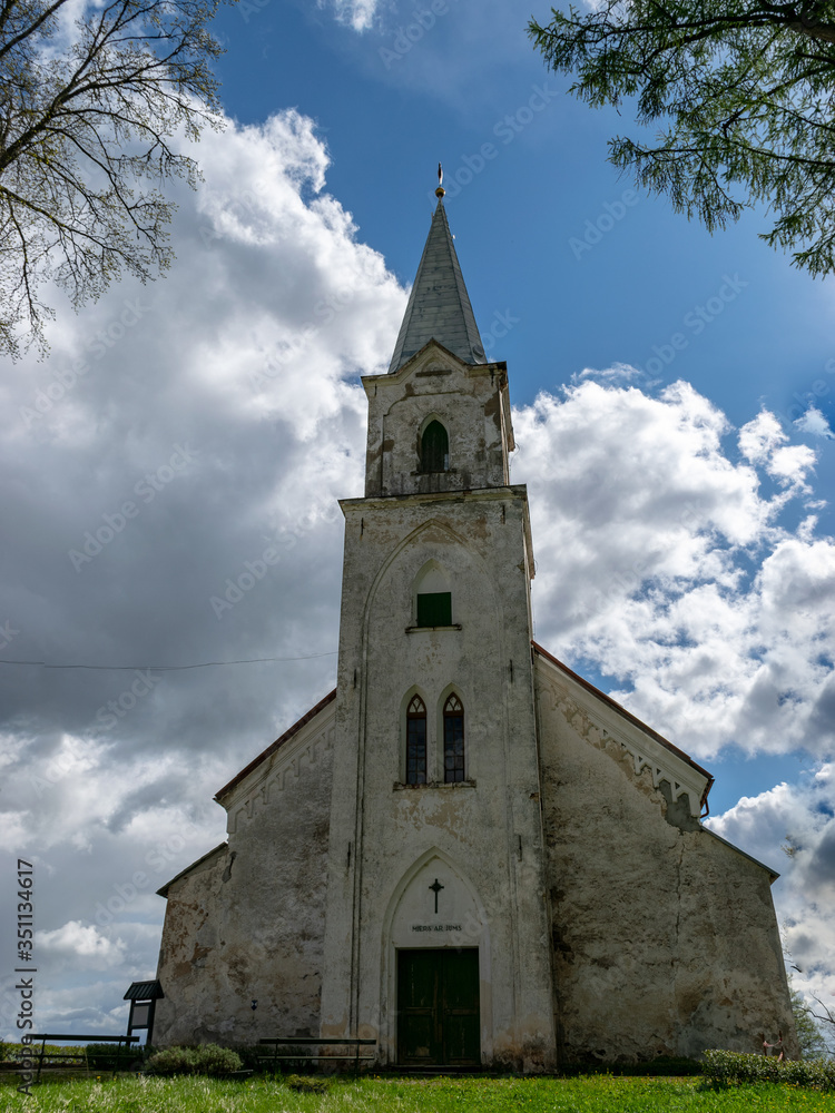 white church on the hill, beautiful blue sky with white cumulus clouds, Trikata church, Latvia